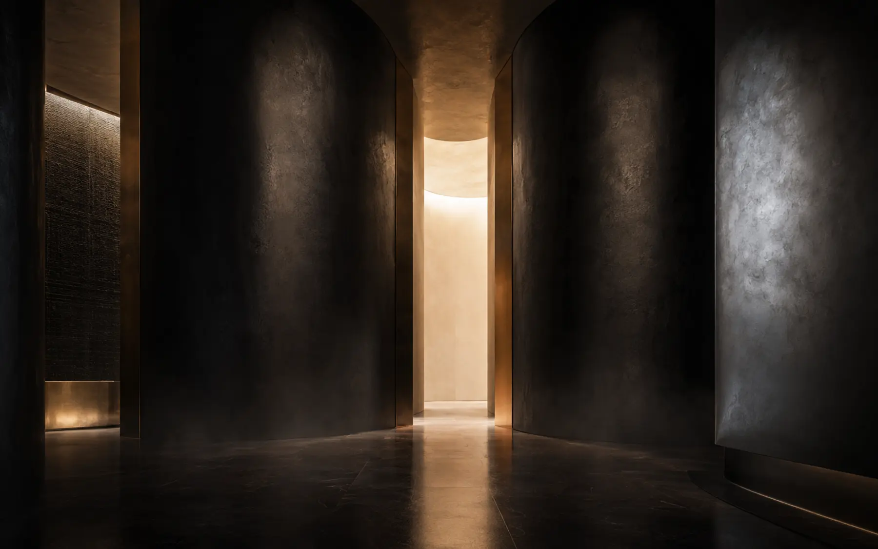 A dark architectural passage opening into warm light